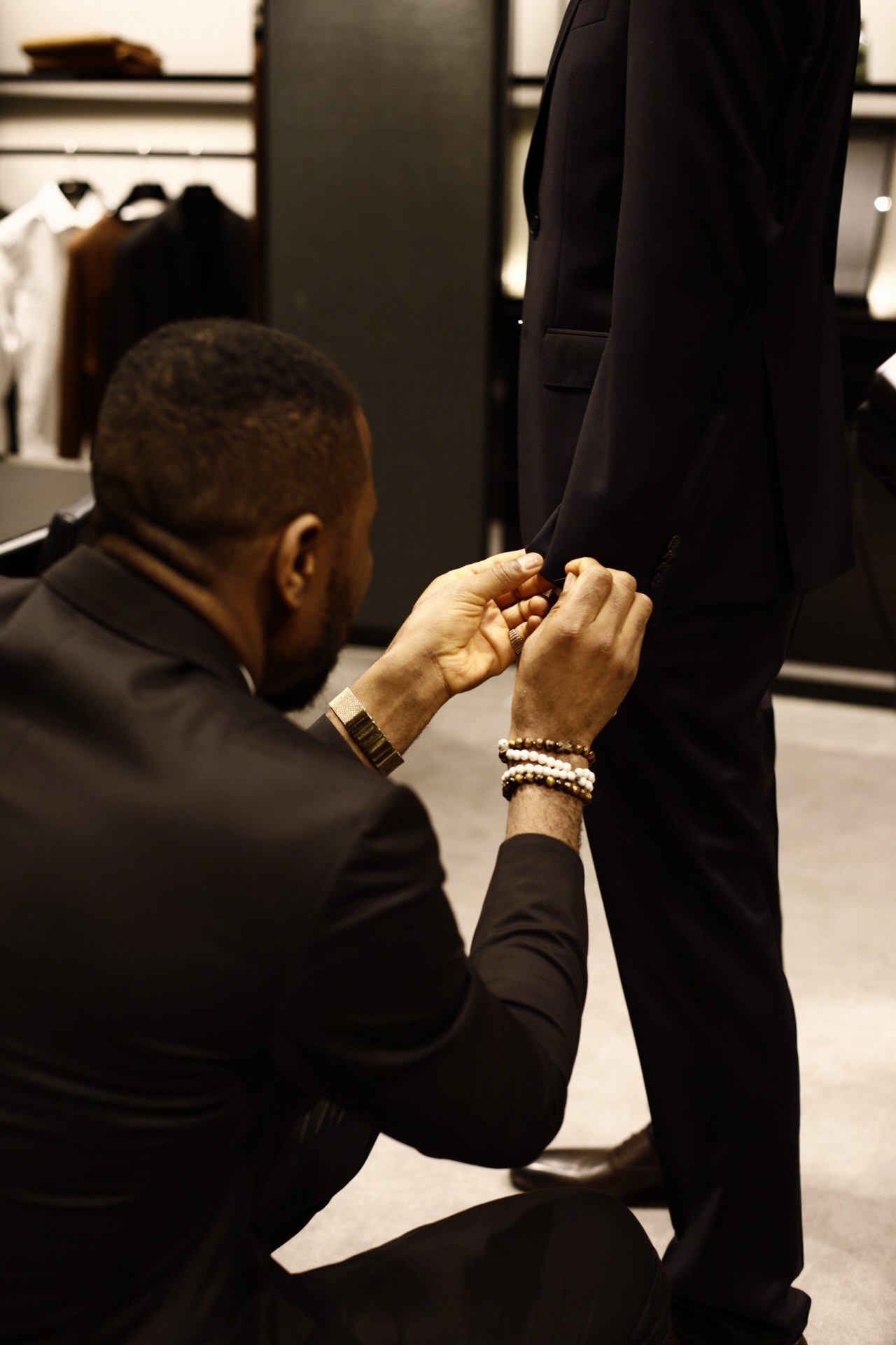 A tailored jacket sleeve being fitted during a personal styling session